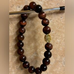 Hand crafted unisex stretch bracelet burgundy red tiger eye gold tone focal 8 in